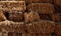 Golden hay bales stacked like bricks forming a straw wall Royalty Free Stock Photo