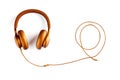 Golden headphones with a wire twisted into a spiral on a white background. View from above. Headphones for DJs