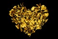 Golden heart made of flower petals on black background isolated closeup, decorative gold heart shape ornament, art floral pattern