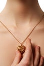 Golden heart pendant. Beauty and jewelry concept. Woman wearing Royalty Free Stock Photo