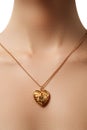 Golden heart pendant. Beauty and jewelry concept. Woman wearing Royalty Free Stock Photo