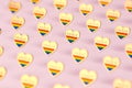 Golden heart with rainbow and word PRIDE inside. Month of pride concept. on pastel pink background. 3D rendering