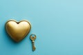 A golden heart-shaped lock and key on a light blue background Royalty Free Stock Photo