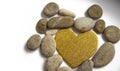 Golden heart and stones on a white background Royalty Free Stock Photo