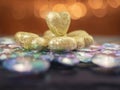 Golden hearts with glitter on a glass snowflake, Saint Valentine theme. Blurred warm bokeh background Royalty Free Stock Photo