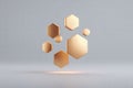 Golden hexagonal shapes float in an abstract and modern 3D rendering against a gray backdrop. Royalty Free Stock Photo
