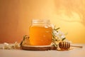 Golden honey in embossed glass jar, complemented by white blossoms, set against a warm amber Royalty Free Stock Photo