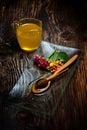 Golden honey on plate and colorful flowers Royalty Free Stock Photo