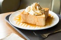 Golden honey toast in the white dish with whipped cream on top