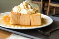 Golden honey toast in the white dish with whipped cream on top Royalty Free Stock Photo