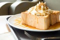 Golden honey toast in the white dish with whipped cream on top Royalty Free Stock Photo