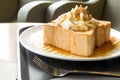 Golden honey toast in the white dish with whipped cream on top Royalty Free Stock Photo