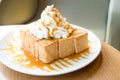 Golden honey toast in the white dish with whipped cream on top Royalty Free Stock Photo