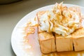 Golden honey toast in the white dish with whipped cream on top Royalty Free Stock Photo