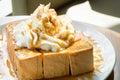 Golden honey toast in the white dish with whipped cream on top Royalty Free Stock Photo