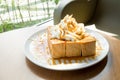 Golden honey toast in the white dish with whipped cream on top Royalty Free Stock Photo