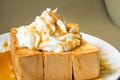 Golden honey toast in the white dish with whipped cream on top Royalty Free Stock Photo