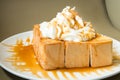 Golden honey toast in the white dish with whipped cream on top Royalty Free Stock Photo