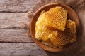 Golden honeycombs on a wooden plate. Horizontal top view