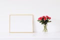 Golden horizontal frame and bouquet of rose flowers on white furniture, luxury home decor and design for mockup creation
