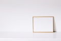 Golden horizontal frame on white furniture, luxury home decor and design for mockup creation