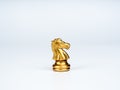The golden horse, knight chess piece standing alone isolated on white background. Royalty Free Stock Photo