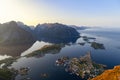 Reinebringen, Lofoten Islands, showcasing serene Reinefjorden, rugged peaks under midnight sun\'s glow Royalty Free Stock Photo