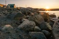 Golden hour in Inuit community of Qikiqtarjuaq, Broughton Island, Nunavut, Canada. Big boulders with houses in the