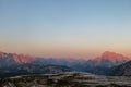 Golden hour in Italian Dolomites. The mountains are shining with pink and orange. Sunrise in high mountains. Morning haze. Royalty Free Stock Photo