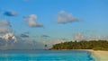 Golden hour in the Maldives. Sandy beach, turquoise ocean