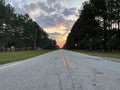 Golden hour morning sun end of country paved road ground view Royalty Free Stock Photo