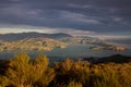 The evening sun lights up the harbour and surrounding hills Royalty Free Stock Photo