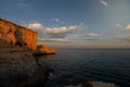 Golden Hour Serenity: Horizontal Landscape Capturing the Tranquil Beauty of a Rocky Cliff Overlooking the Ocean at Sunset, Royalty Free Stock Photo