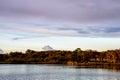 Golden hour sunlight over the Sarasota Bay. Tropical trees and boat dock on the Gulf of Mexico Florida Coastline Royalty Free Stock Photo