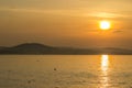 Golden hour sunset at Colwyn bay, North Wales. Warm sky with seagulls sitting on the water. Royalty Free Stock Photo