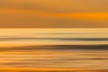 Golden hour, sunset over the sea abstract seascape background. Motion blur, line art, vibrant gold colors Royalty Free Stock Photo