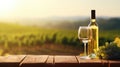 Golden Hour Vineyard Setting With Wine Bottle, Glass, and Fresh Grapes on a Rustic Table Royalty Free Stock Photo