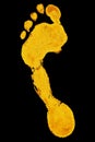 Golden human barefoot footprint on black background isolated closeup, shiny gold metal person foot print illustration, yellow foot