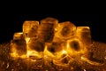 Golden ice cubes on black background isolated closeup, transparent frozen melting amber color water drops, yellow light Royalty Free Stock Photo