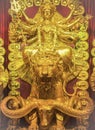 Golden idol of a Hindu Goddess riding a Lion