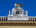 The golden Imperial eagle statue on the Schoenbrunn palace with the blue sky background