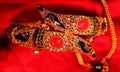 Golden Indian bracelet in red background Royalty Free Stock Photo