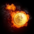 Golden IOTA coin falling in fire flame.