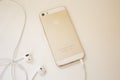 Golden iPhone 5s back and earphone wired - isolated