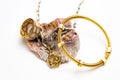 Elegant golden jewelry piece featuring a decorative seashell set on a white background