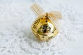 Golden jingle bell Christmas bauble on white