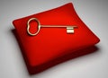 Golden key on red pillow