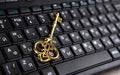 Golden key symbol on black computer keyboard Royalty Free Stock Photo