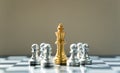 Golden King Chess is surrounded by silver chess, in conceptbusiness, triumph, success and competition. On board chess with a Royalty Free Stock Photo