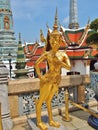 A Golden Kinnara statue at the Temple of the Emerald Buddha, Thailand. Royalty Free Stock Photo